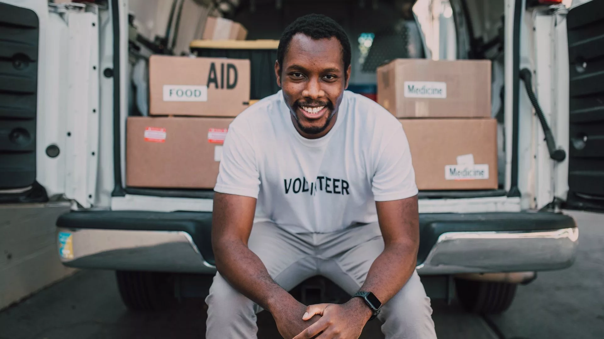 Man sitting in the back of a white van