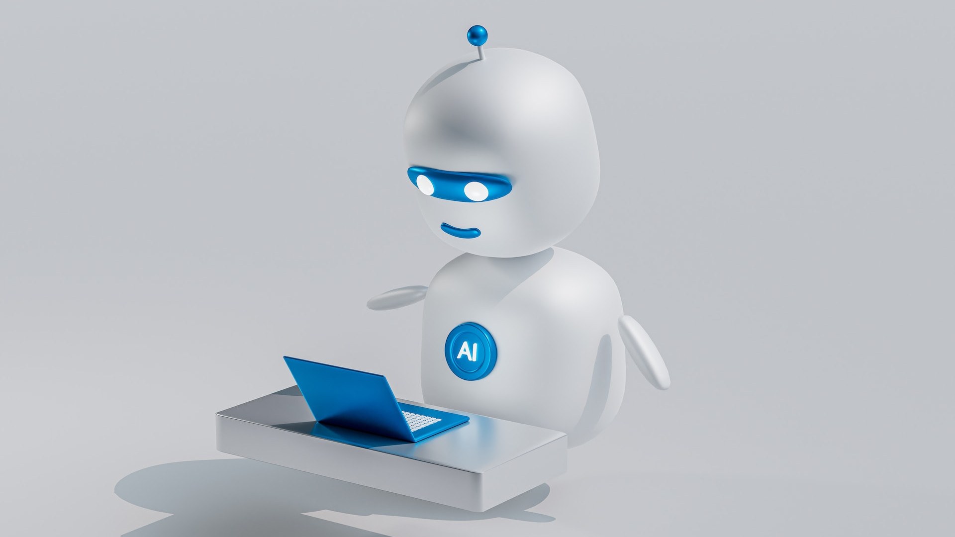 AI Robot sitting in front of a computer doing computer work.