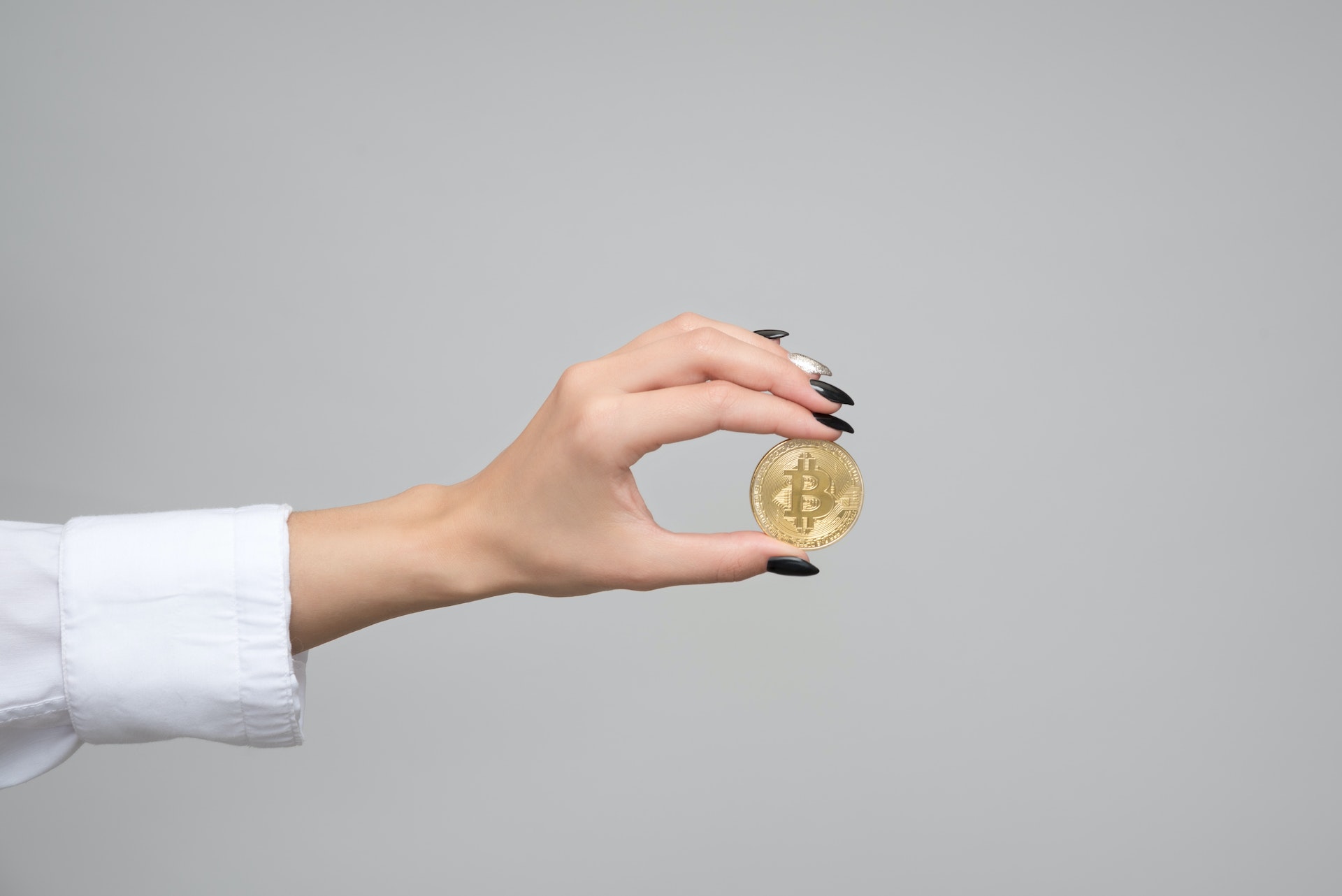 Woman giving one Bitcoin